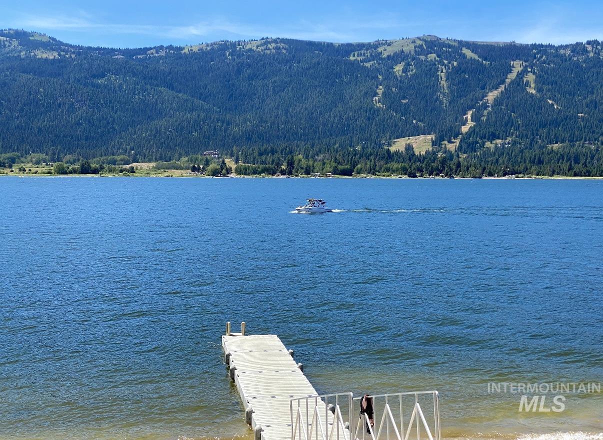 Dock featuring a water and mountain view