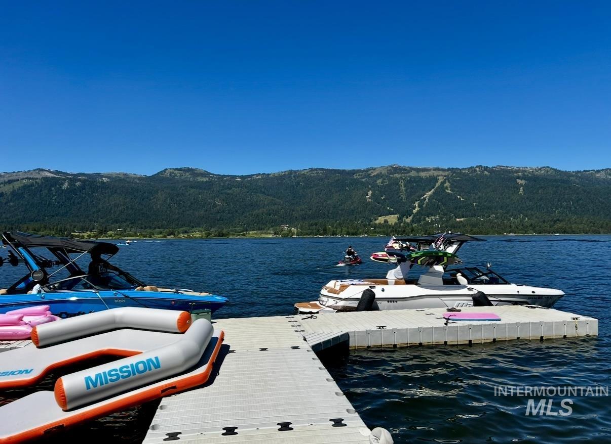 Dock area with a water and mountain view