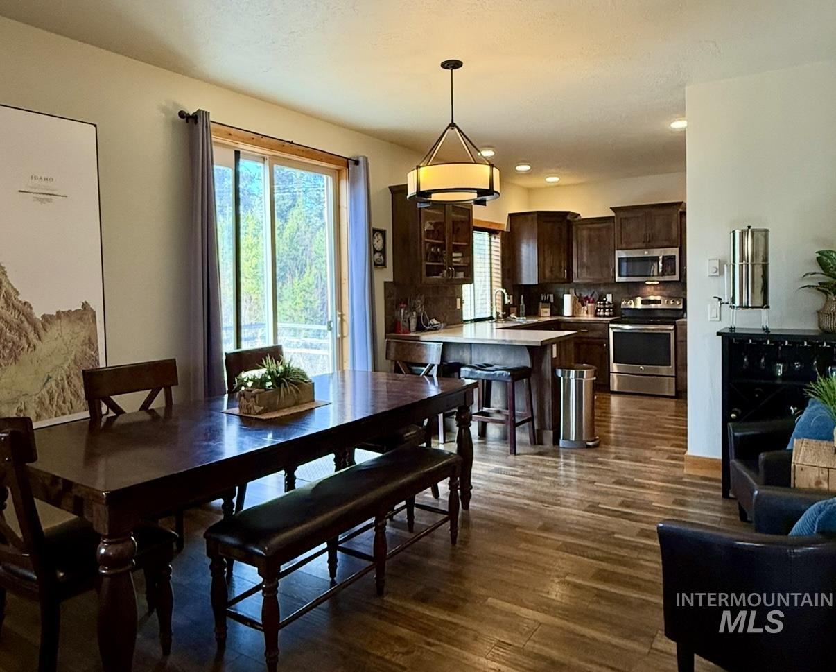 Dining space with dark wood-style floors and recessed lighting