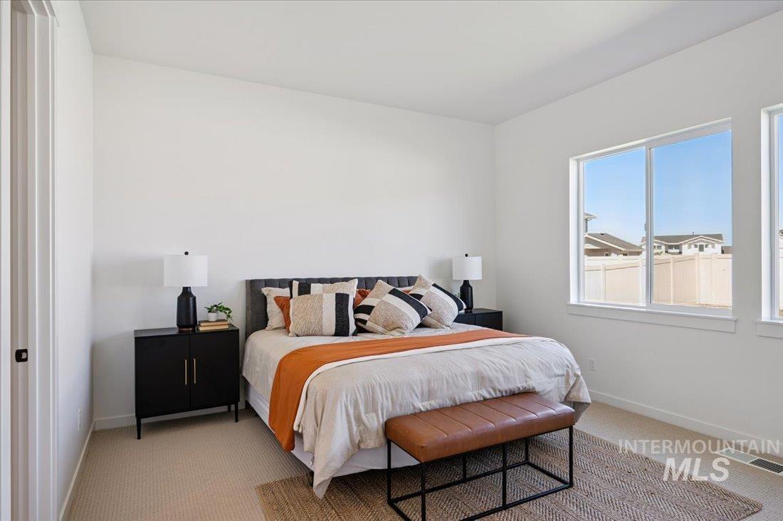 Bedroom with carpet floors and baseboards