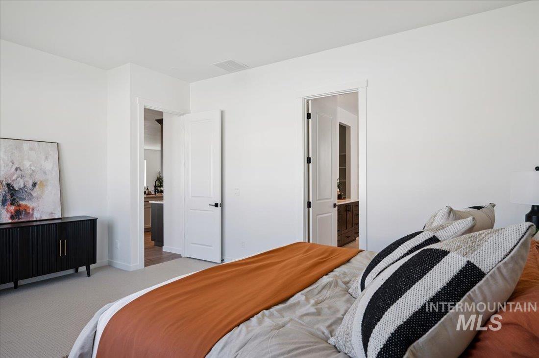 Carpeted bedroom featuring baseboards