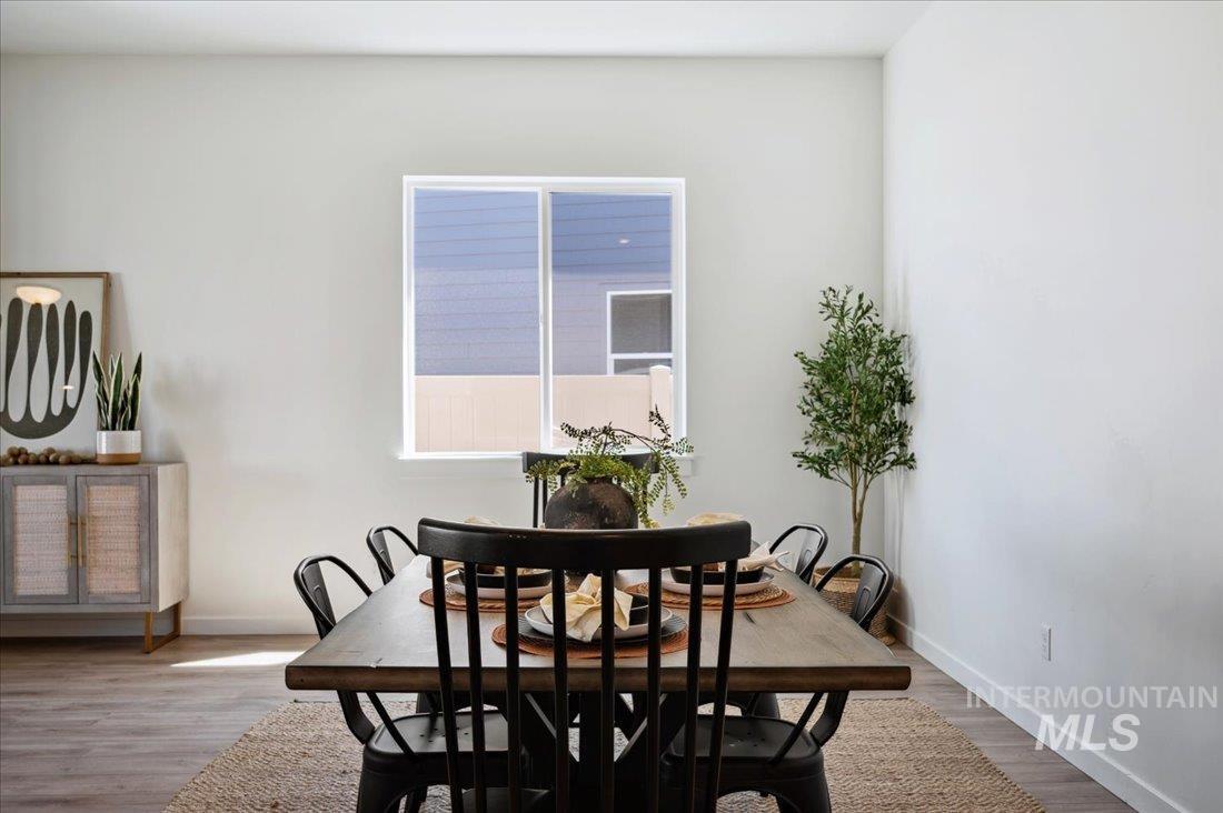 Dining room with baseboards and light wood-style flooring
