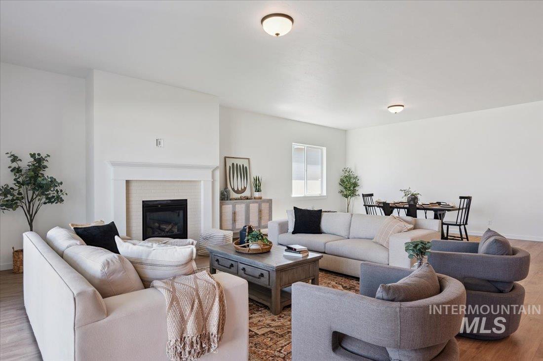 Living room featuring wood finished floors and a brick fireplace