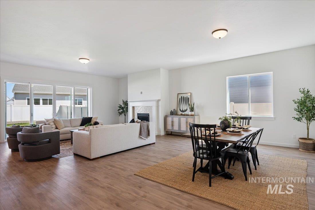 Dining space featuring light wood finished floors and a fireplace