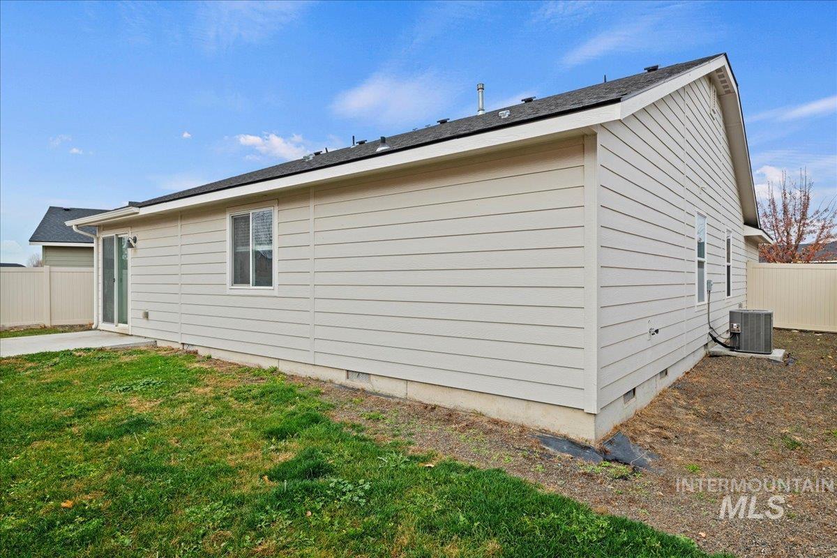 View of side of property with crawl space and a central AC unit