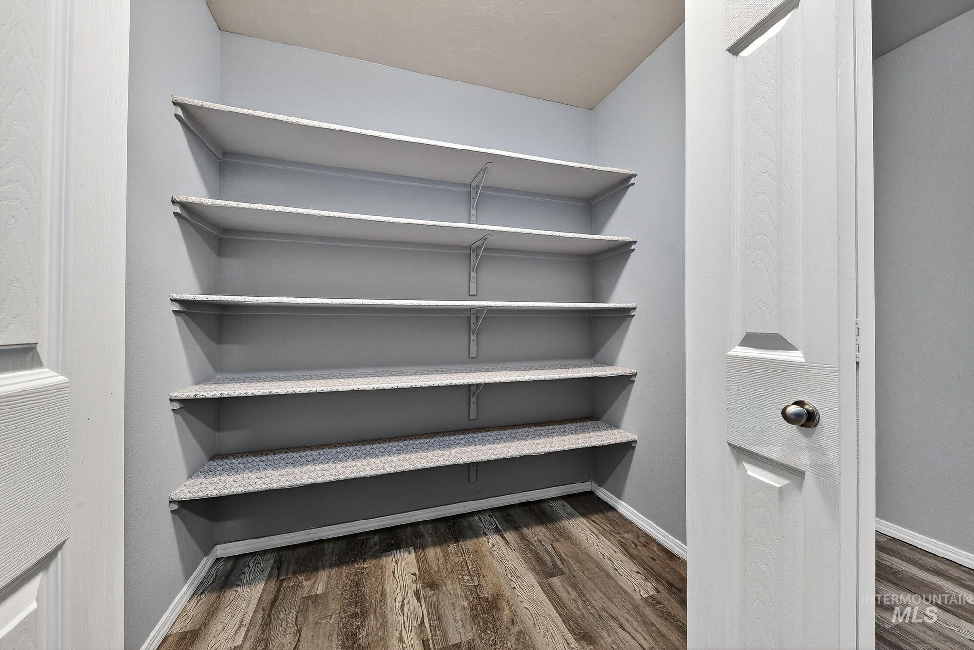Upstairs closet with built in shelving for additional storage