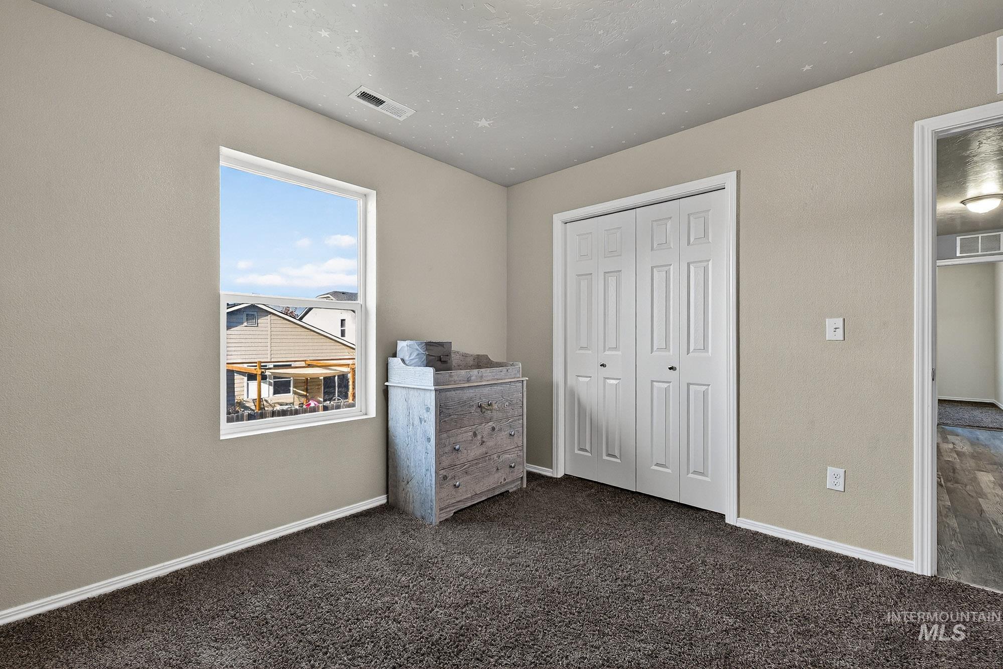 Unfurnished bedroom featuring neutral colored carpet and a closet