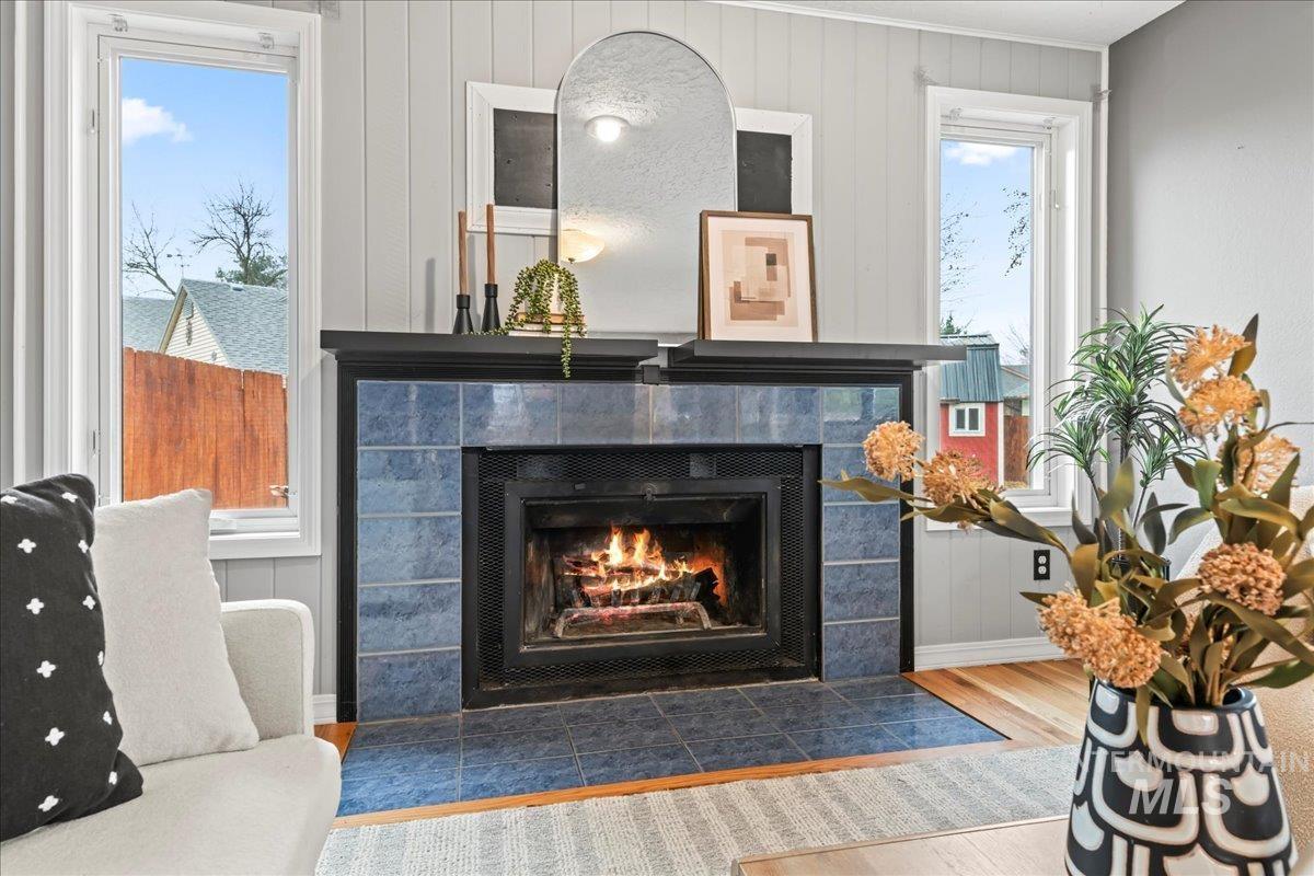Detailed view of wood finished floors and a tile fireplace
