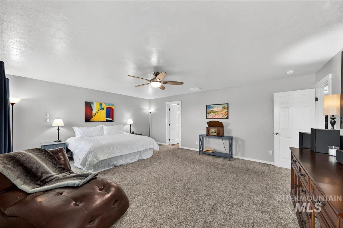 Bedroom with light carpet and ceiling fan