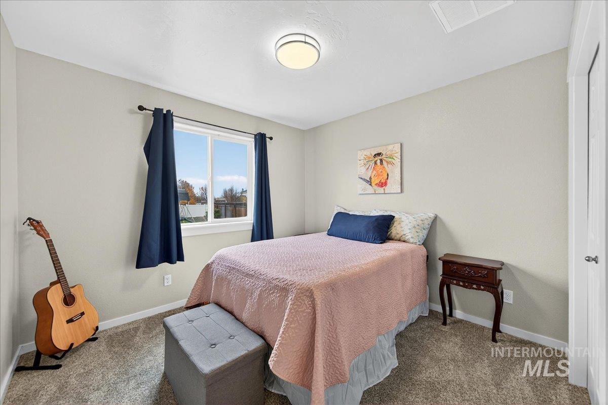 Carpeted bedroom with baseboards