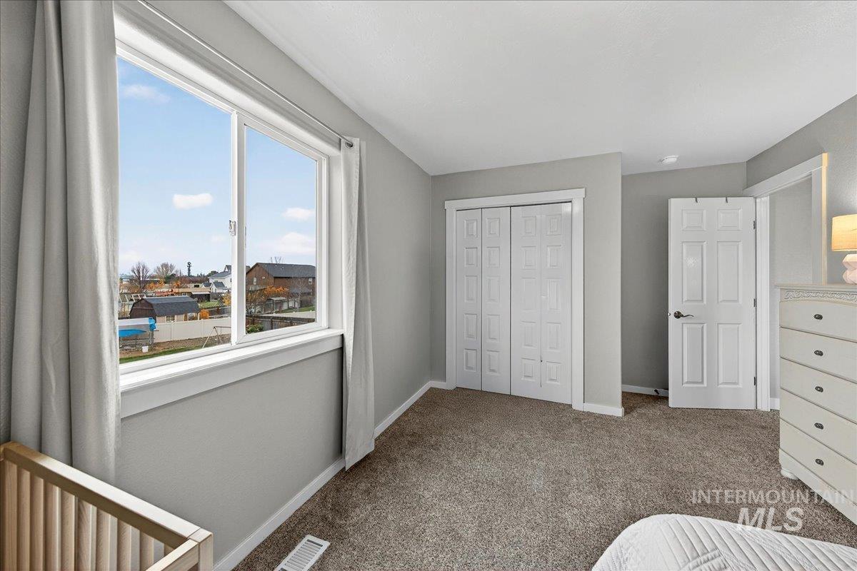 Bedroom featuring carpet floors and a closet