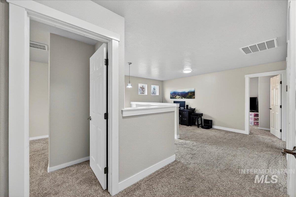 Hall with carpet and baseboards