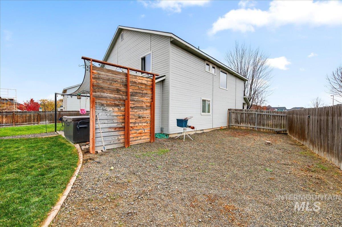Back of house with a fenced backyard