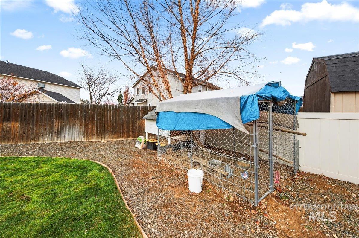 Fenced backyard with an outbuilding and exterior structure