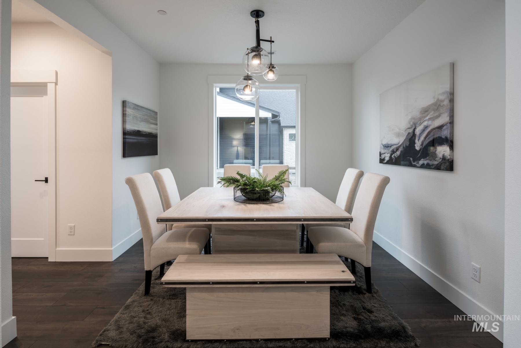 Dining area featuring baseboards and dark wood finished floors