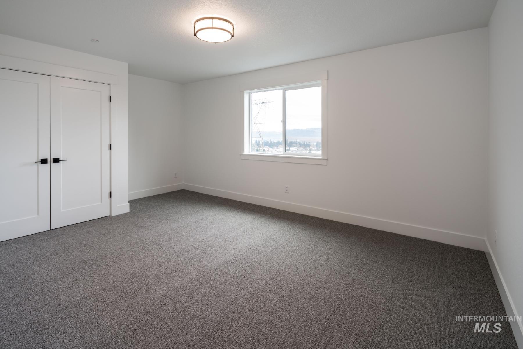 Unfurnished bedroom featuring carpet flooring and a closet