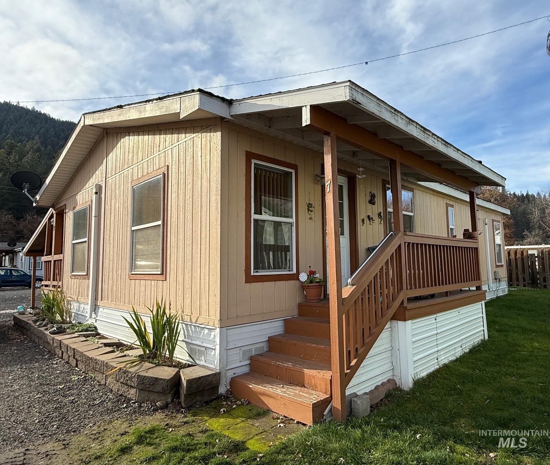 View of front of home featuring covered porch and a front yard