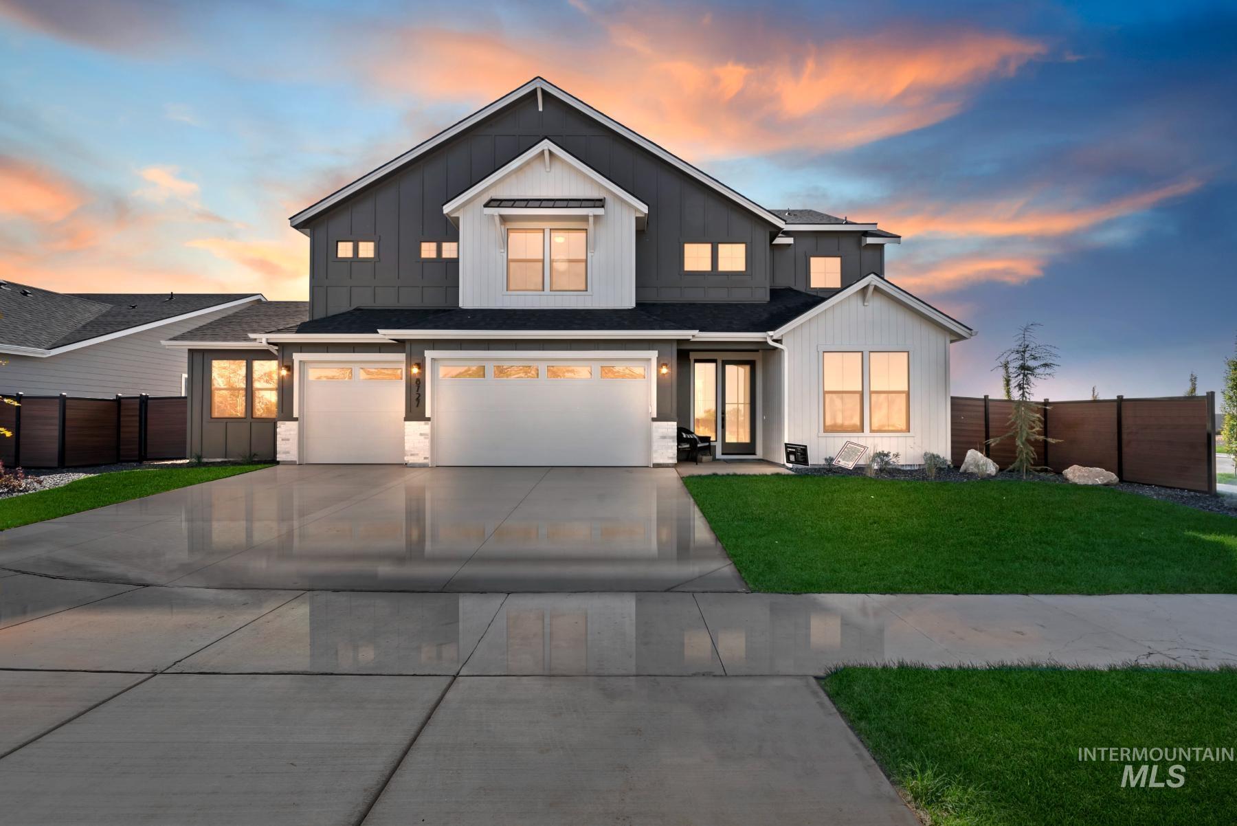 Modern inspired farmhouse with board and batten siding, a garage, concrete driveway, and a shingled roof