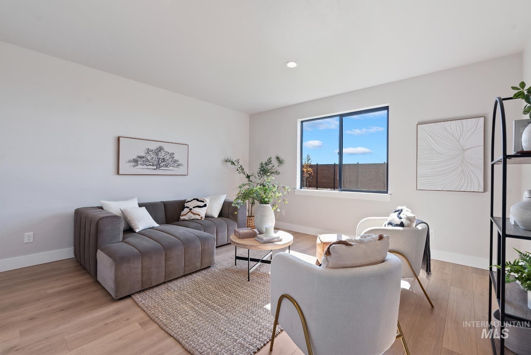 Living area featuring light wood finished floors and recessed lighting
