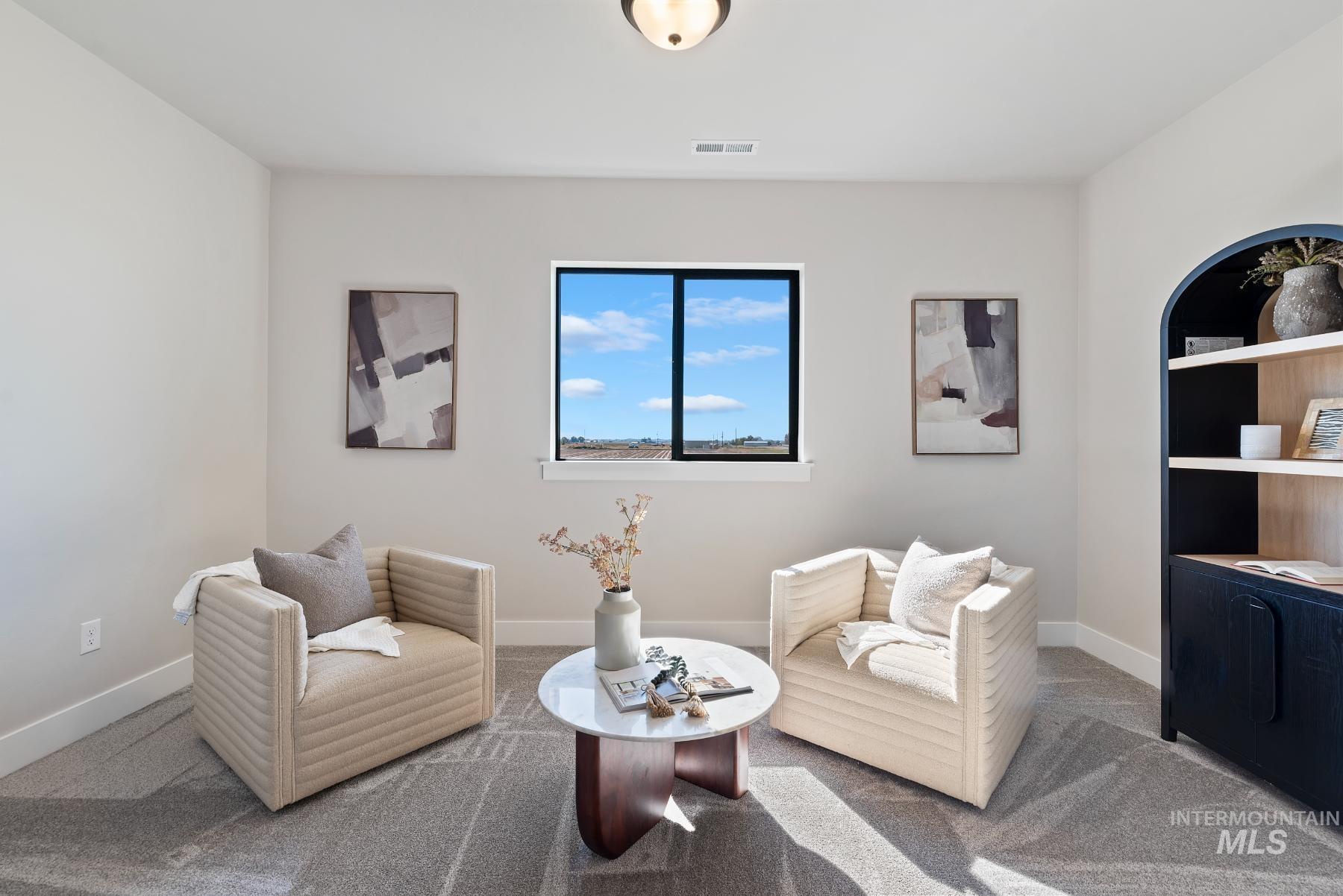 Living area with carpet floors and baseboards