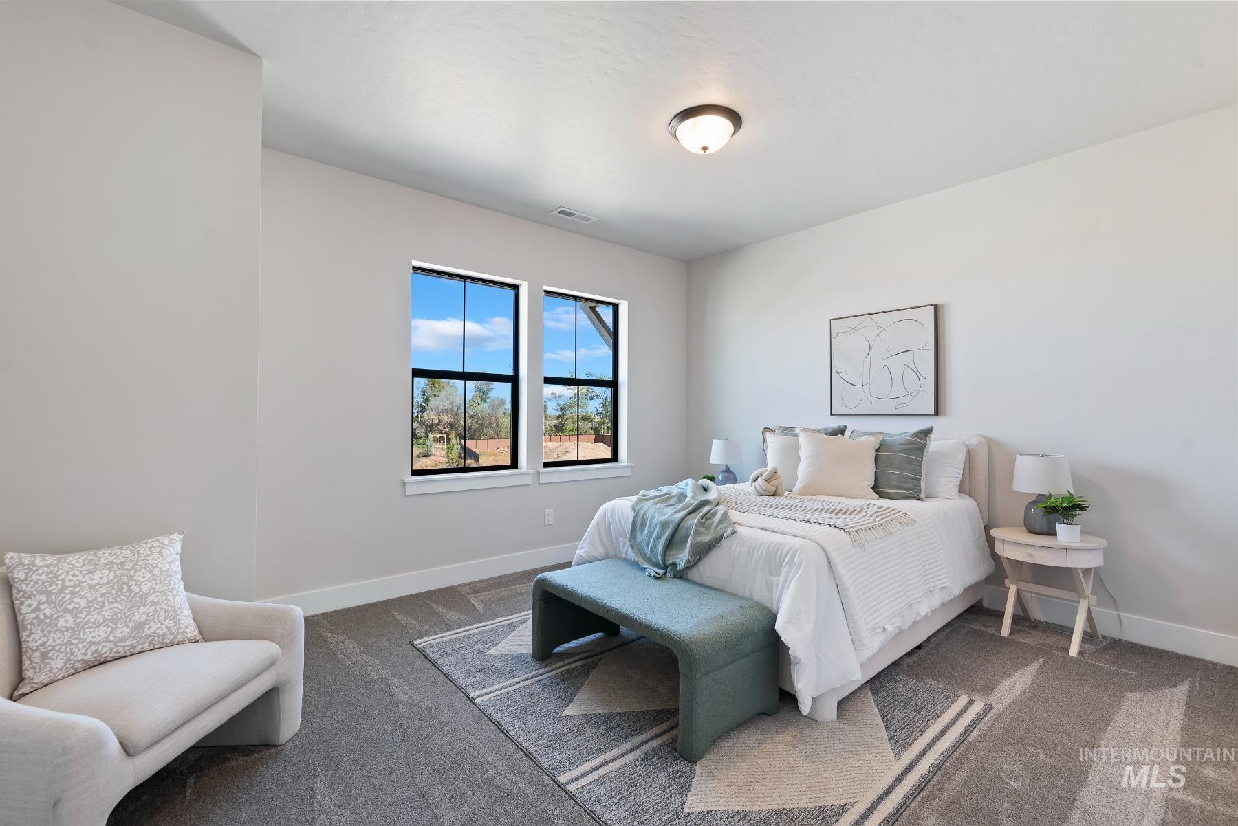 Carpeted bedroom with baseboards