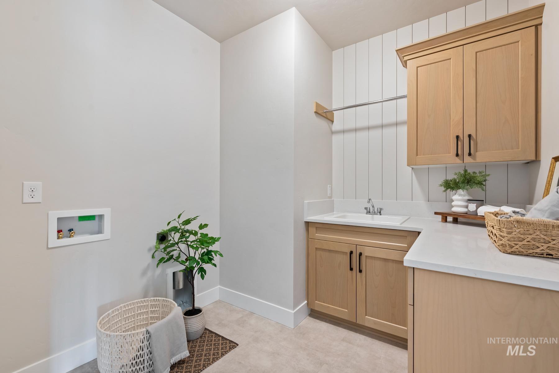Washroom with cabinet space and washer hookup
