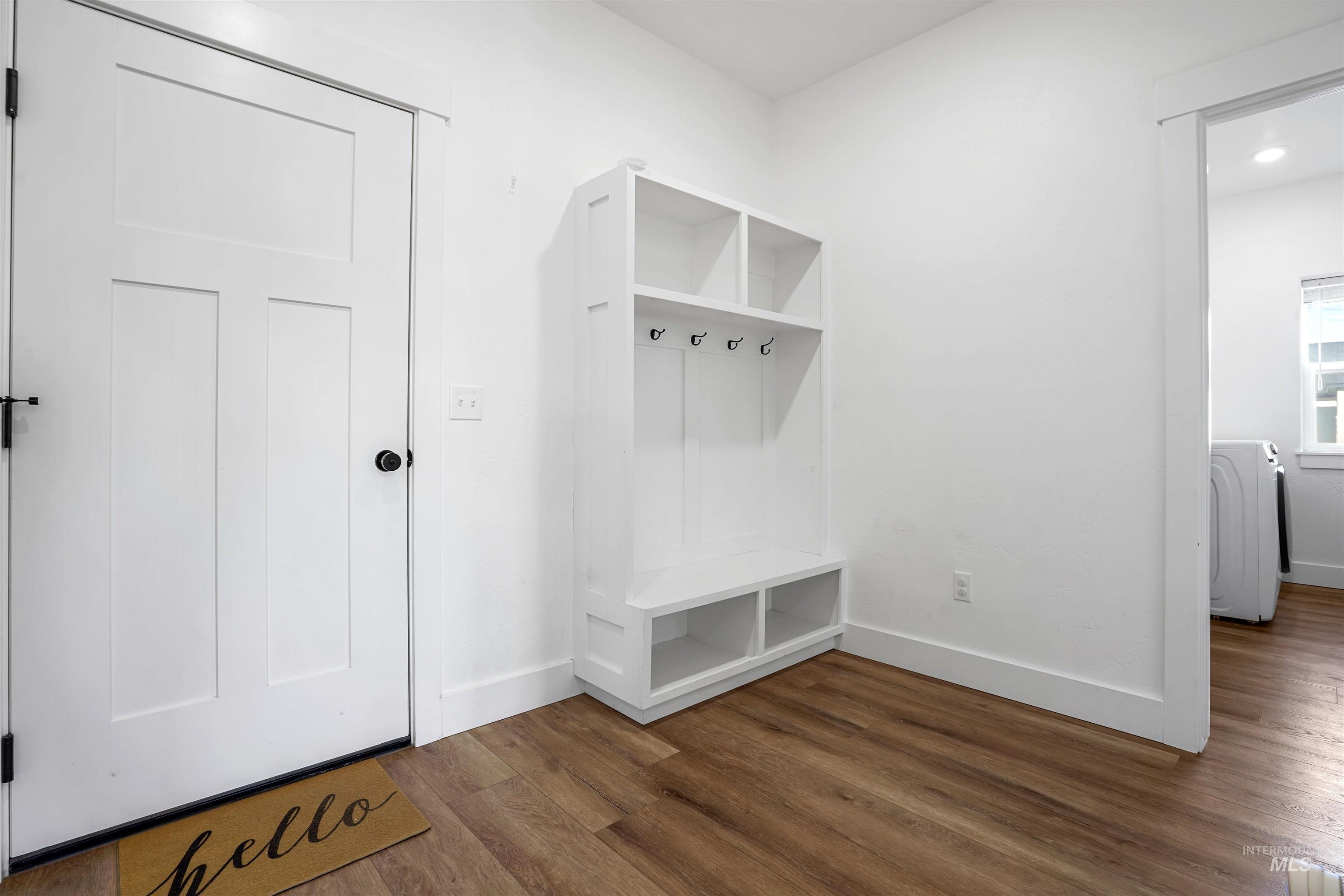 Mudroom with dark wood-type flooring and washer / clothes dryer