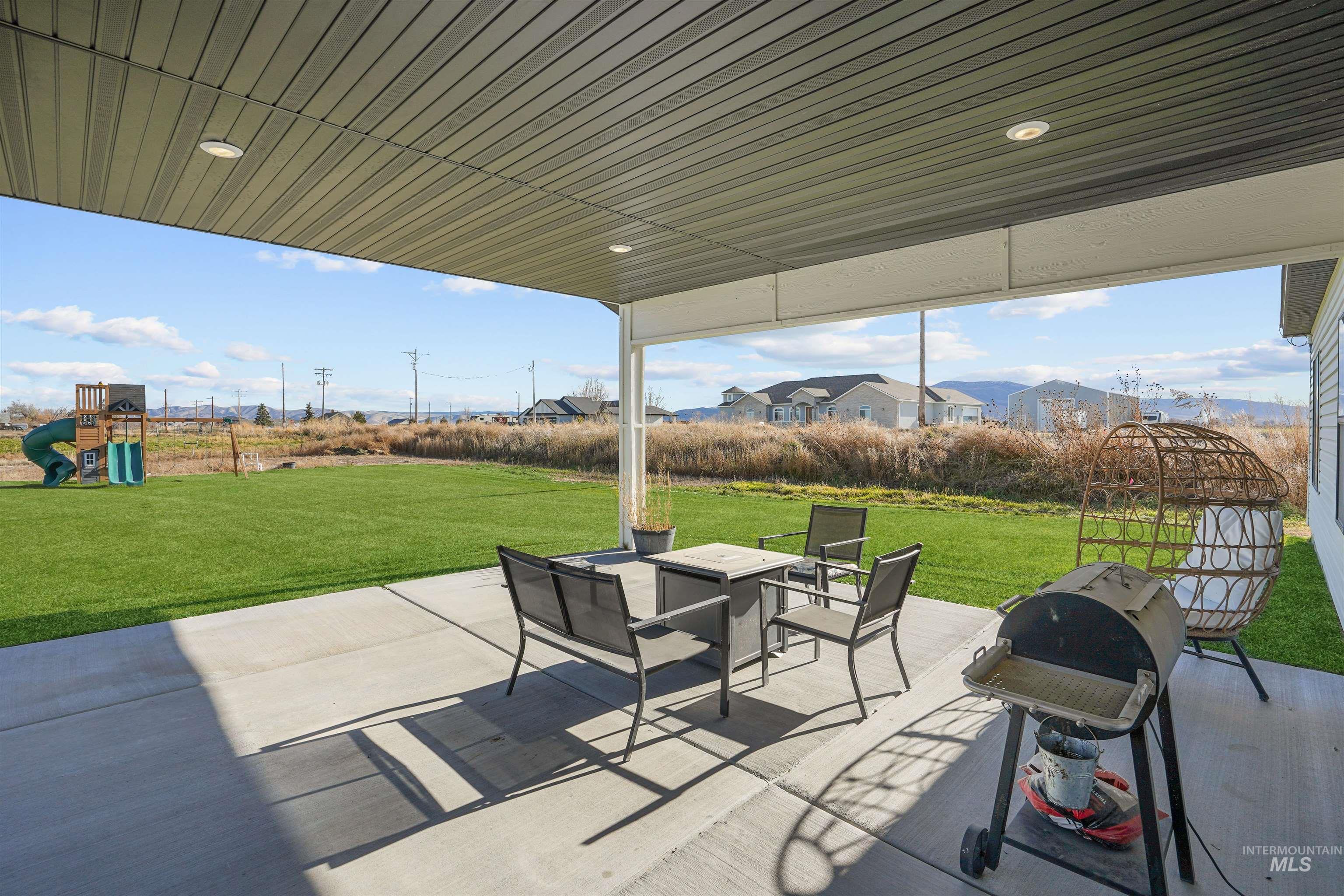 View of patio / terrace with grilling area, a residential view, and a playground