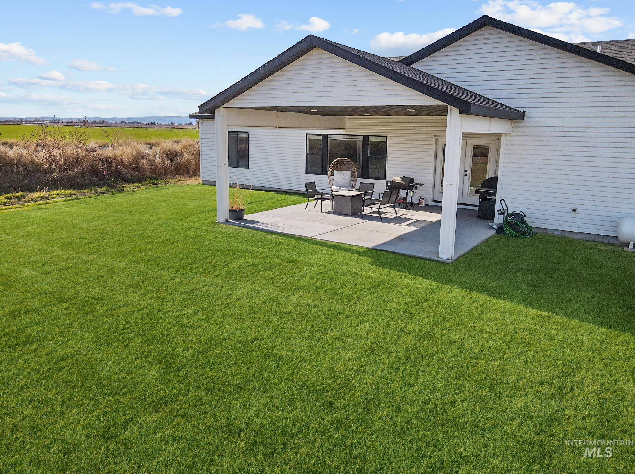 Back of house featuring a patio and a yard