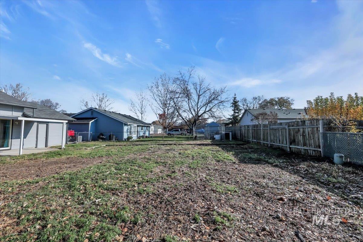 Fenced backyard featuring a residential view and a patio area