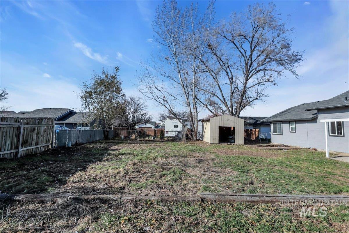 Fenced backyard with a shed
