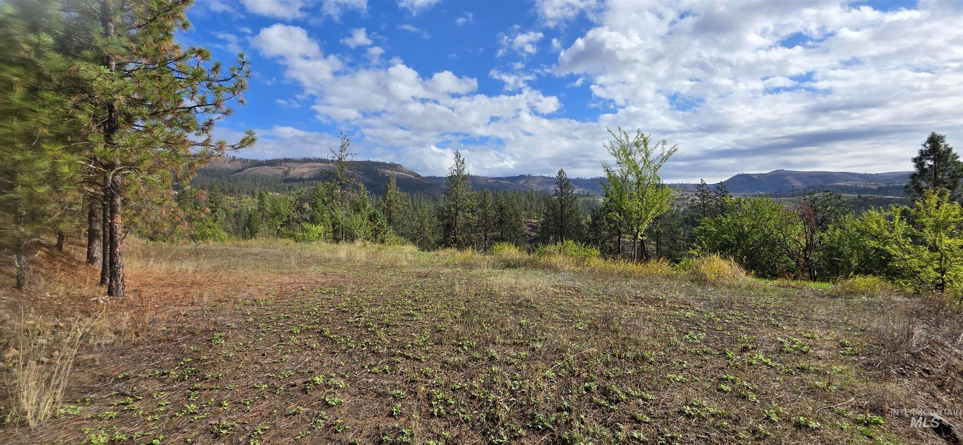 View of mountain backdrop with rural landscape