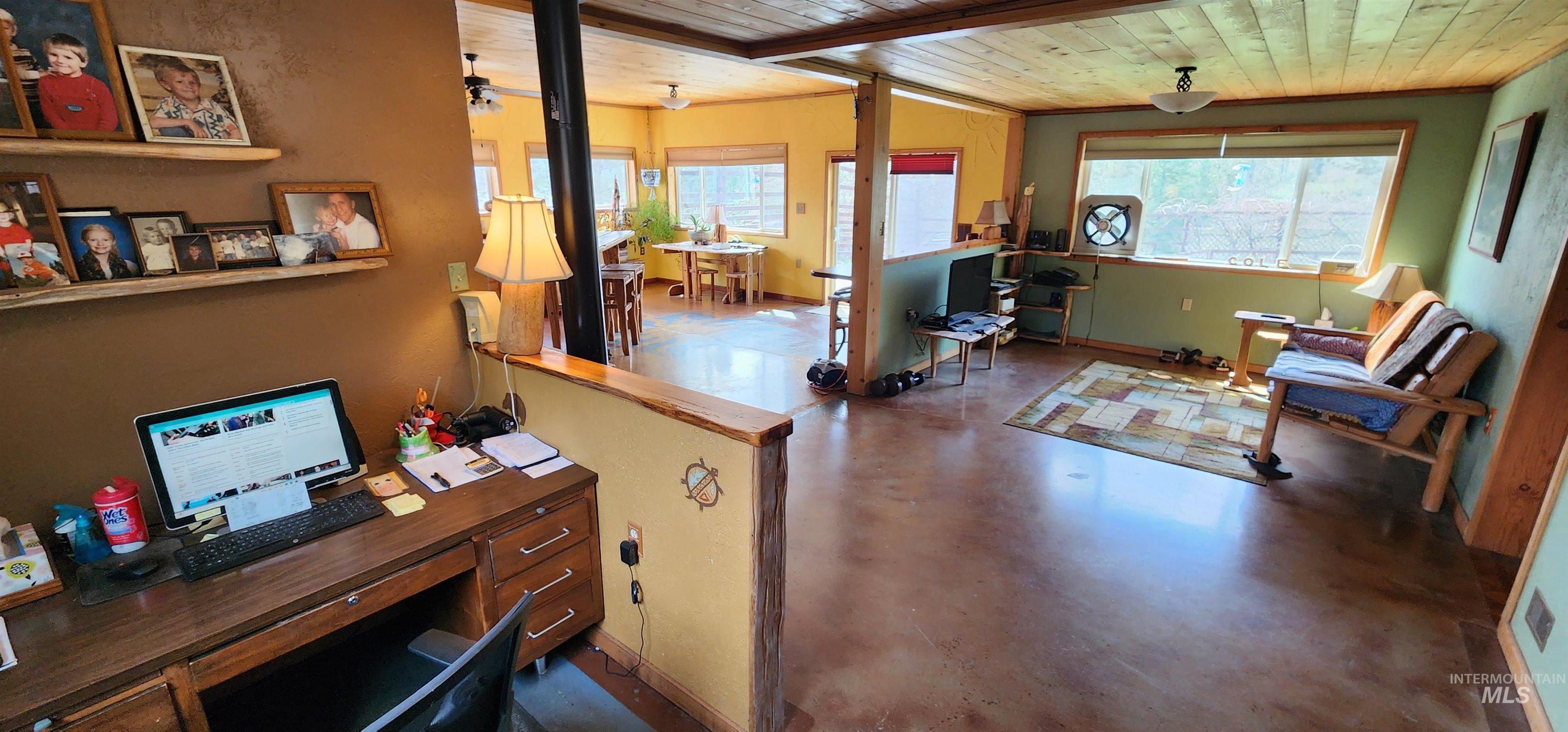 Office area with wood ceiling, finished concrete flooring, and plenty of natural light