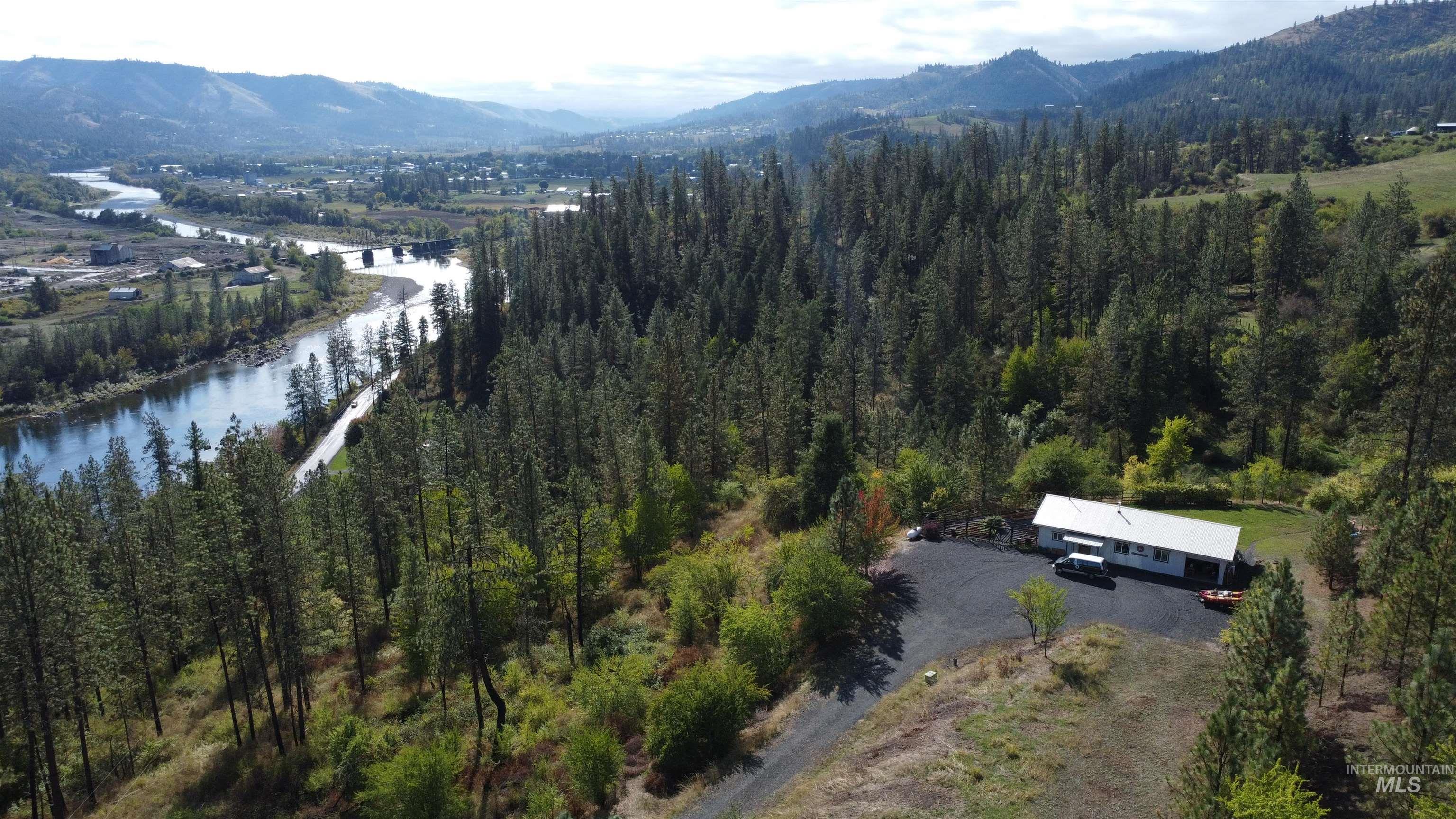 Aerial view of property's location featuring a water and mountain view