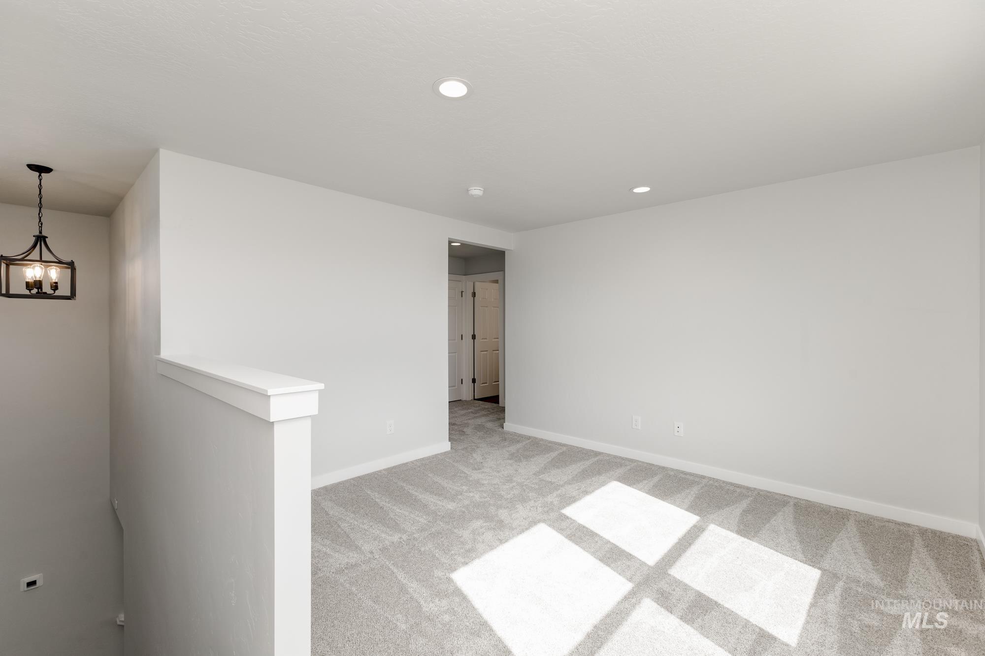 Spare room featuring light carpet and recessed lighting