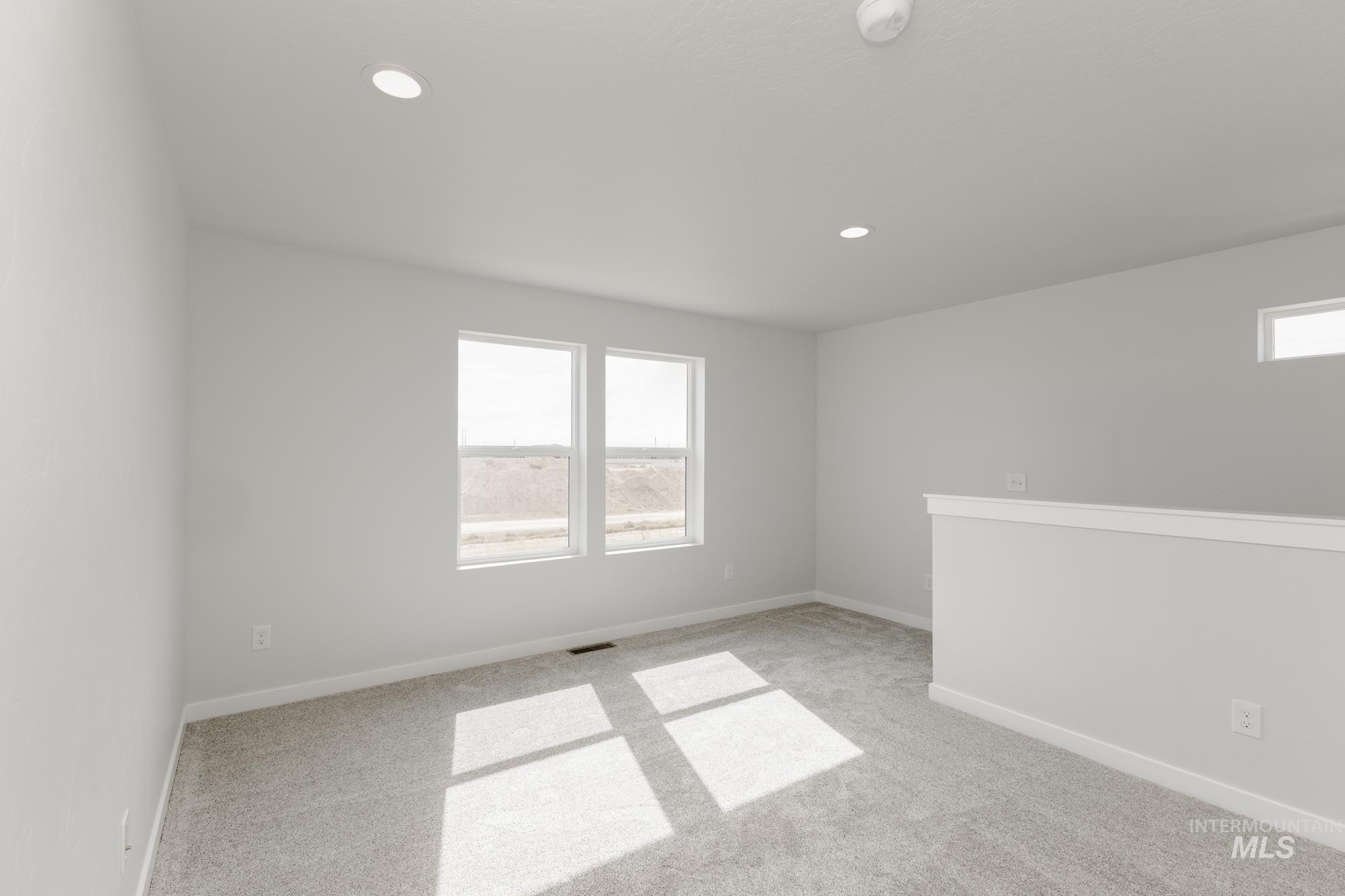 Spare room with carpet and recessed lighting