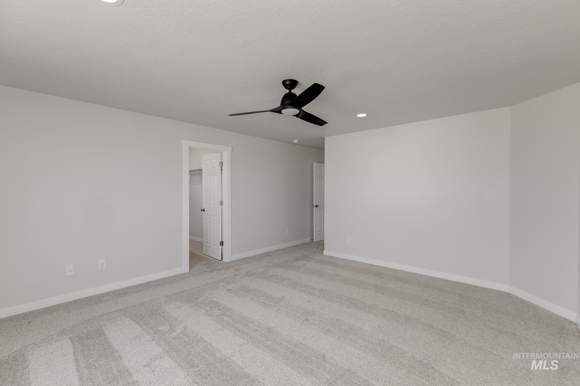 Spare room with light carpet, recessed lighting, and a ceiling fan