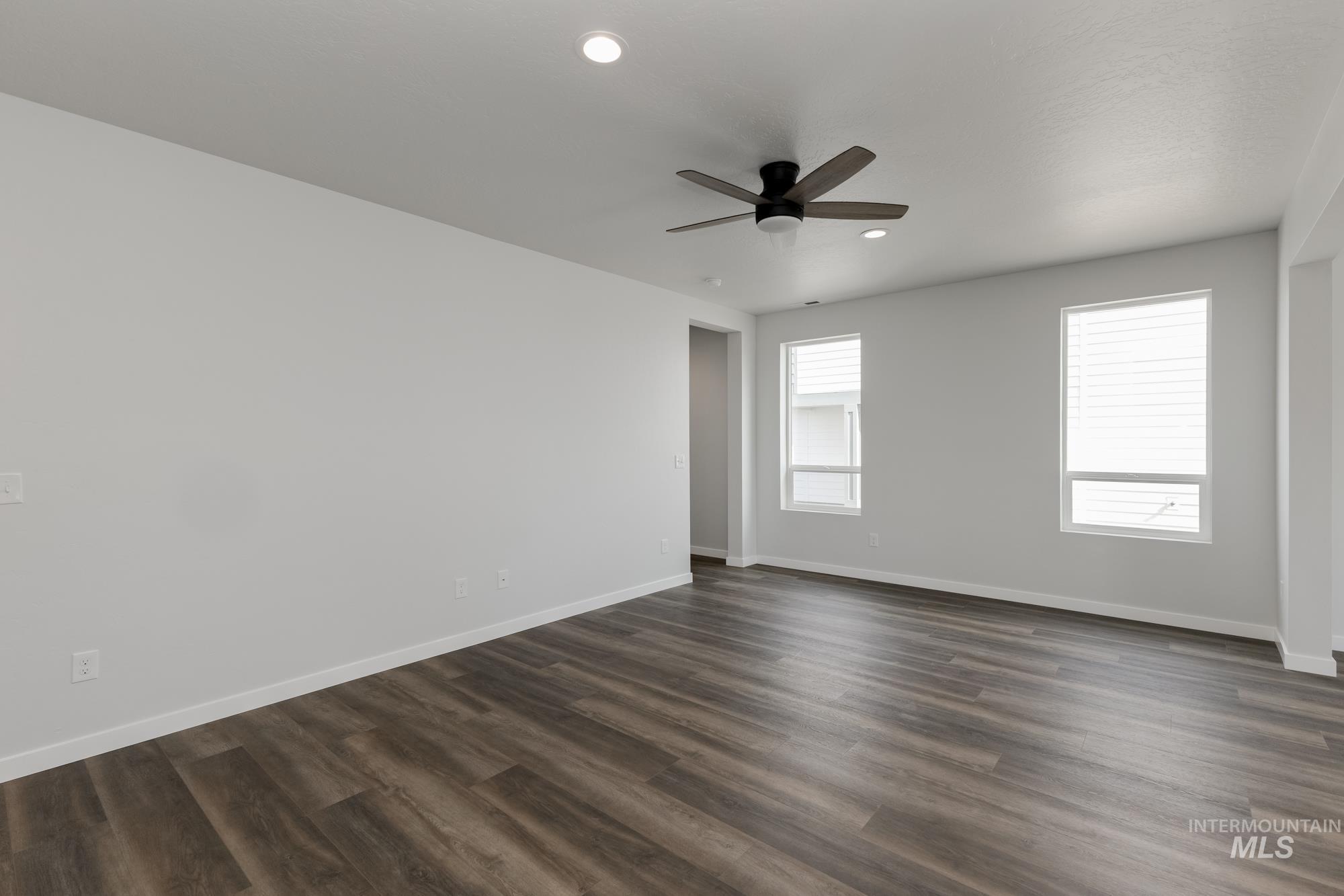Spare room with dark wood-type flooring, recessed lighting, and ceiling fan