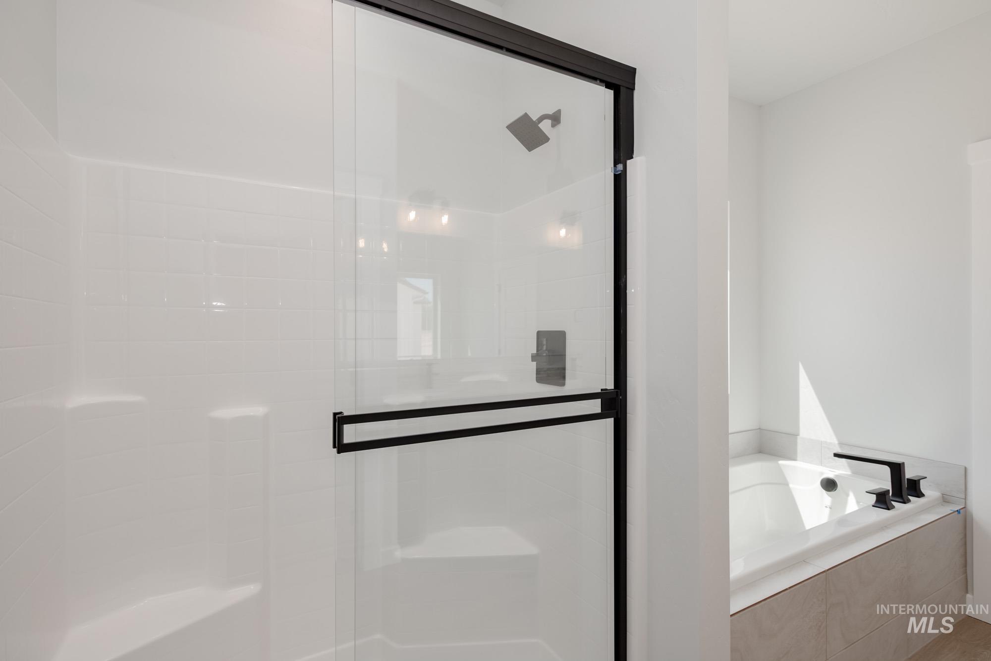 Bathroom with a bath and a shower stall