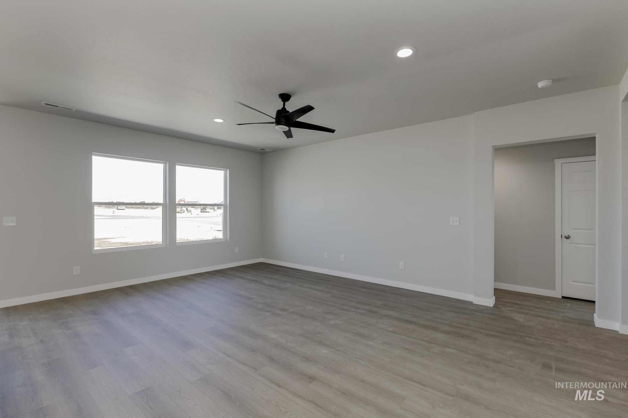 Empty room with light wood finished floors, recessed lighting, and ceiling fan