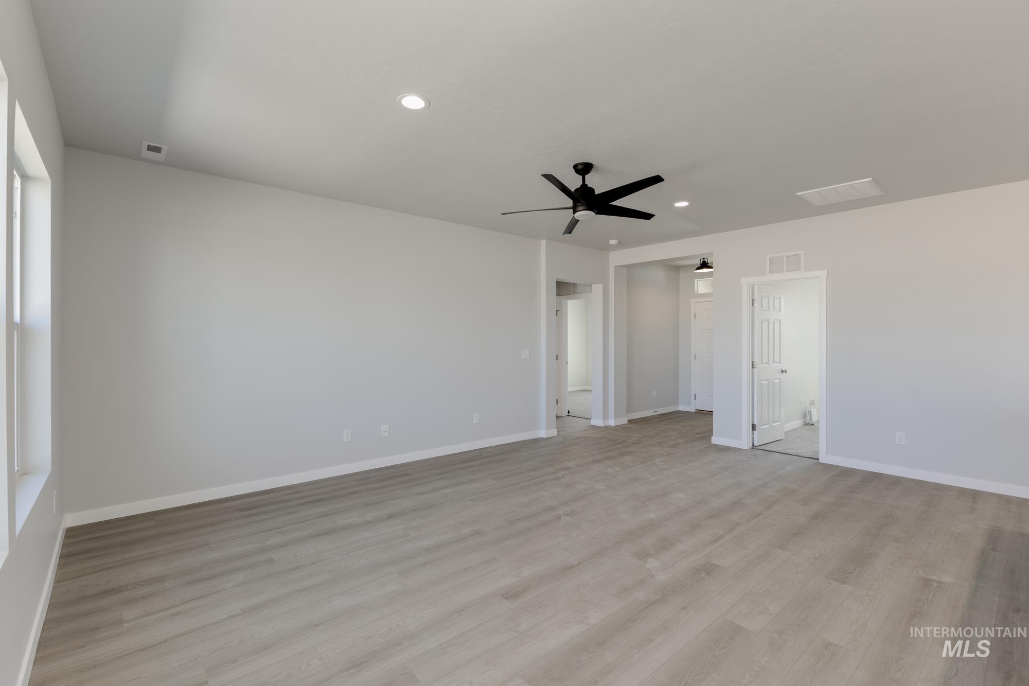 Empty room featuring recessed lighting, light wood-style floors, and a ceiling fan