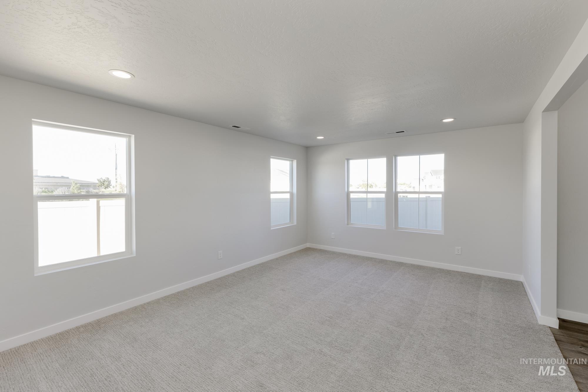 Spare room with light colored carpet and recessed lighting