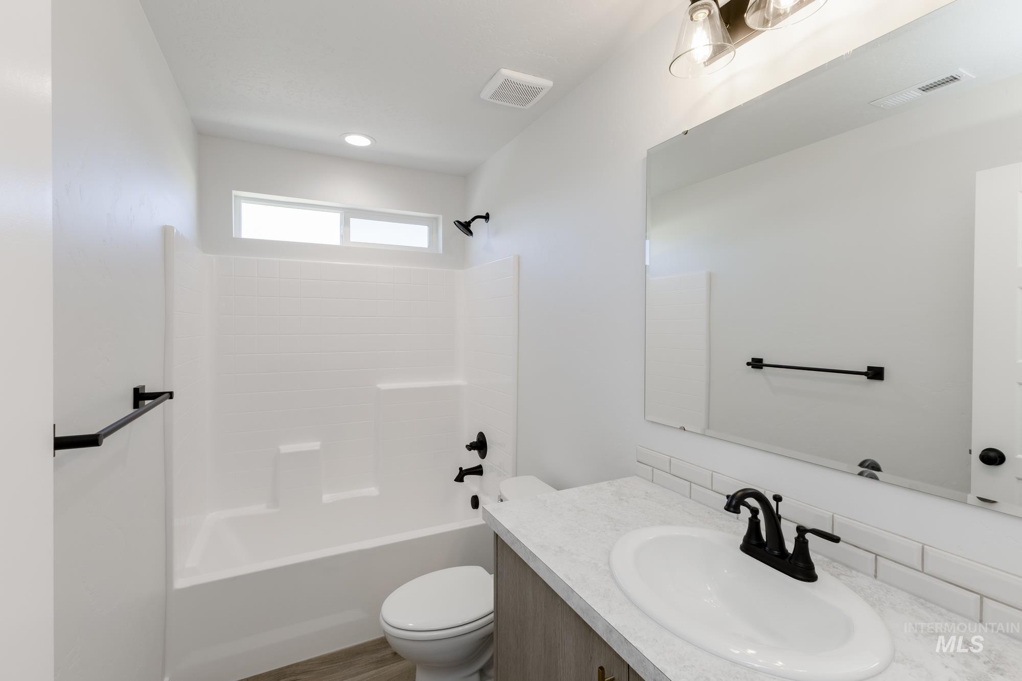 Bathroom featuring washtub / shower combination and vanity