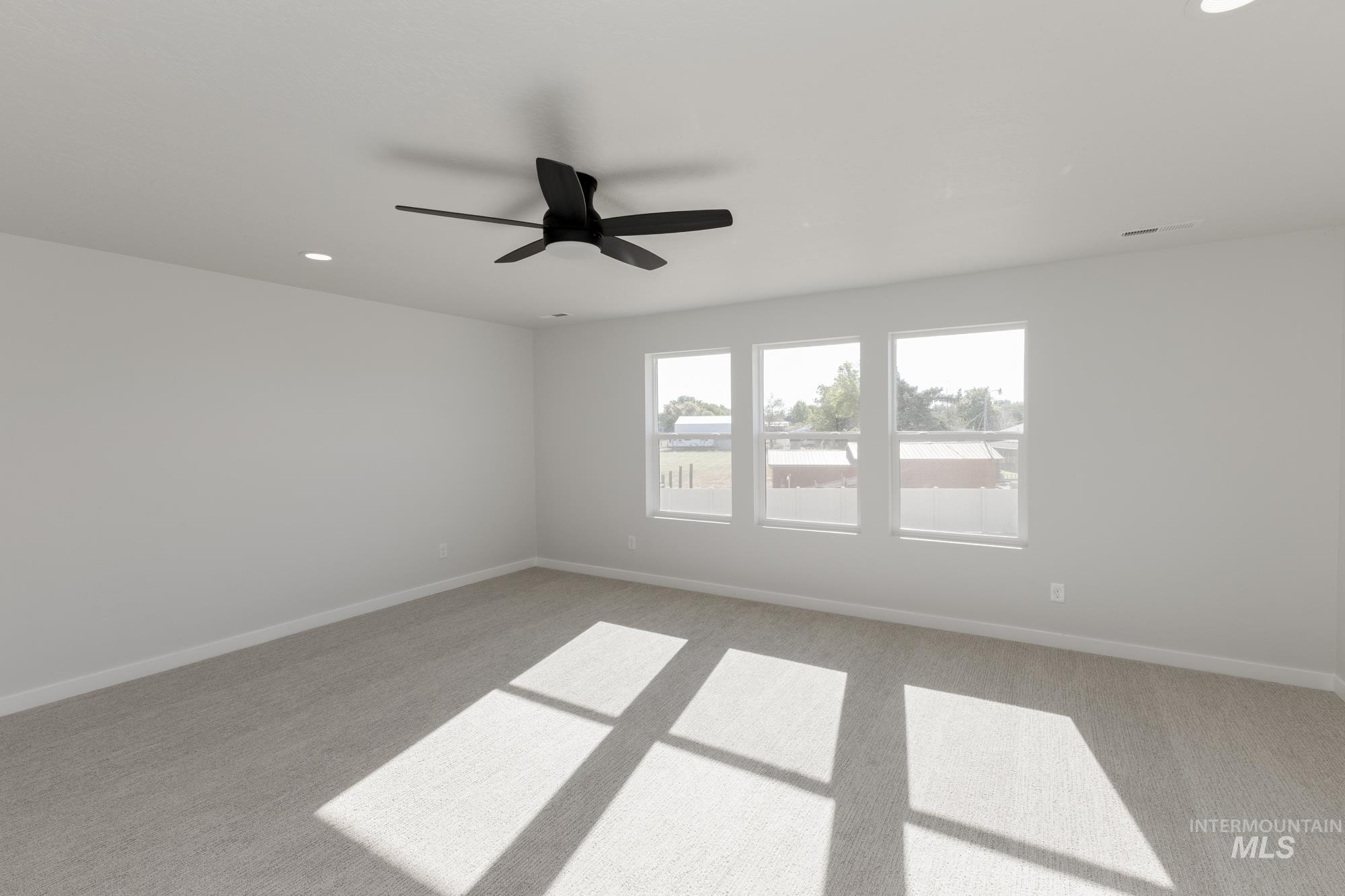 Unfurnished room with light colored carpet, recessed lighting, and a ceiling fan