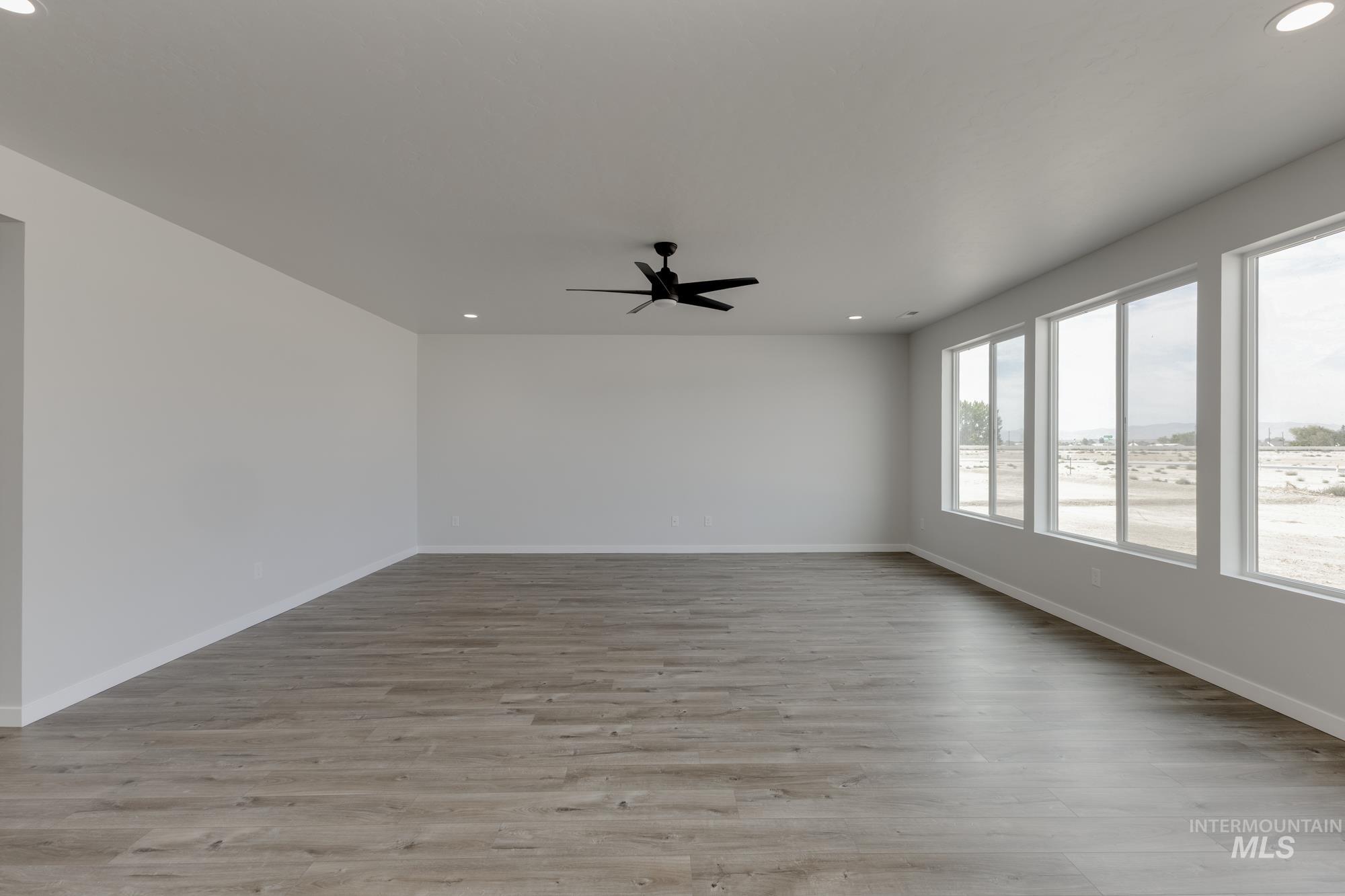 Empty room featuring recessed lighting, light wood-style floors, and ceiling fan