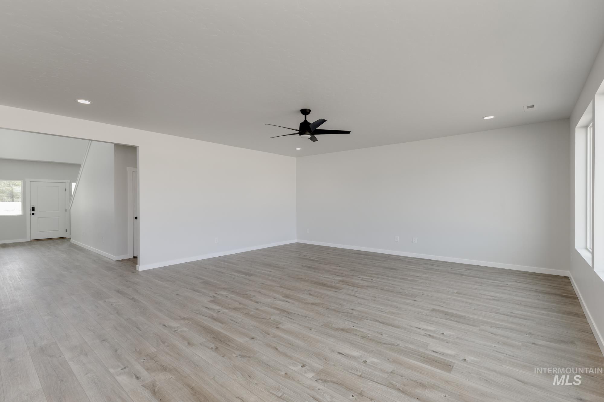 Empty room with recessed lighting, light wood finished floors, and a ceiling fan