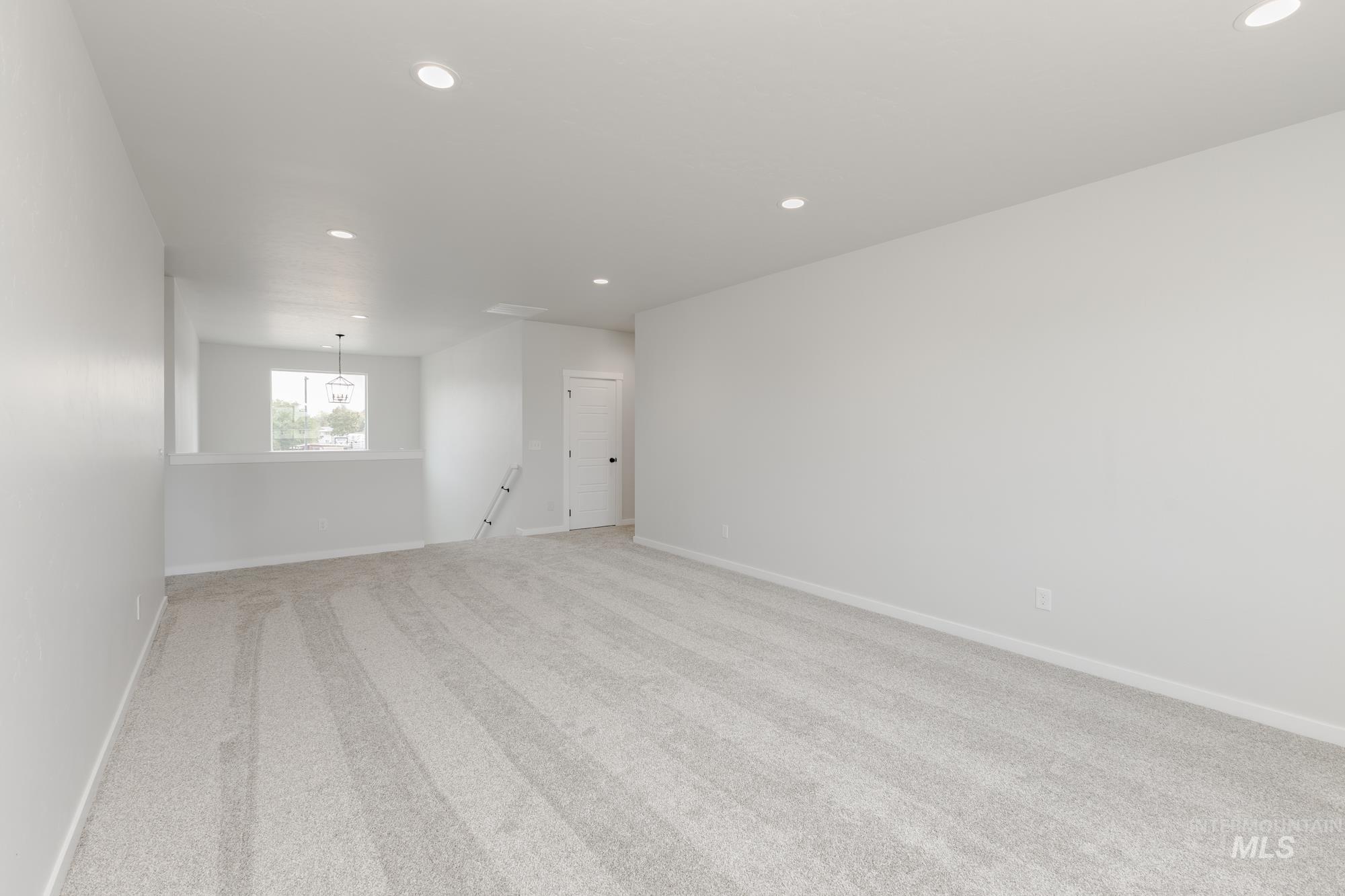 Spare room featuring recessed lighting and light carpet
