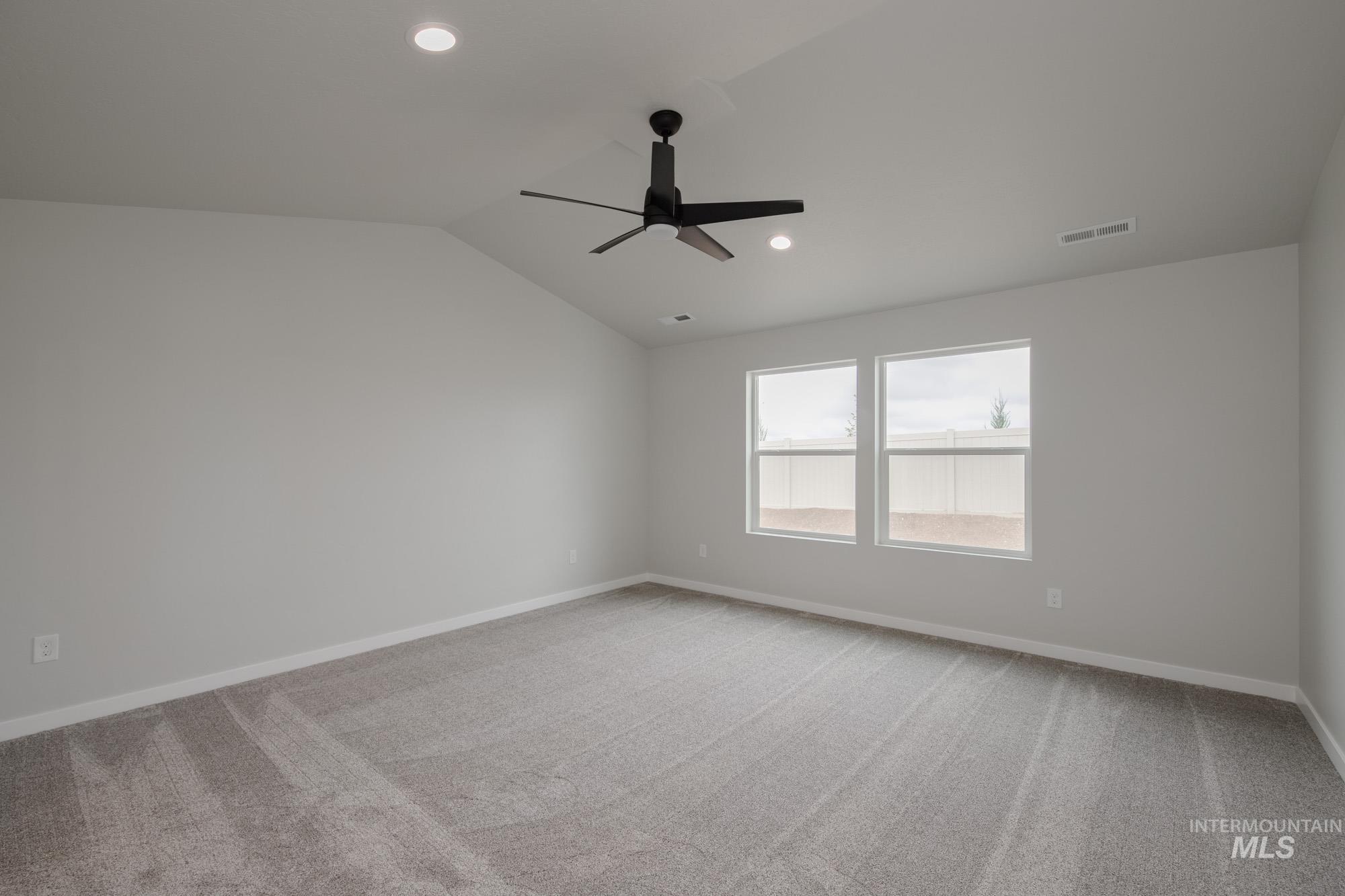 Unfurnished room with light carpet, vaulted ceiling, recessed lighting, and ceiling fan