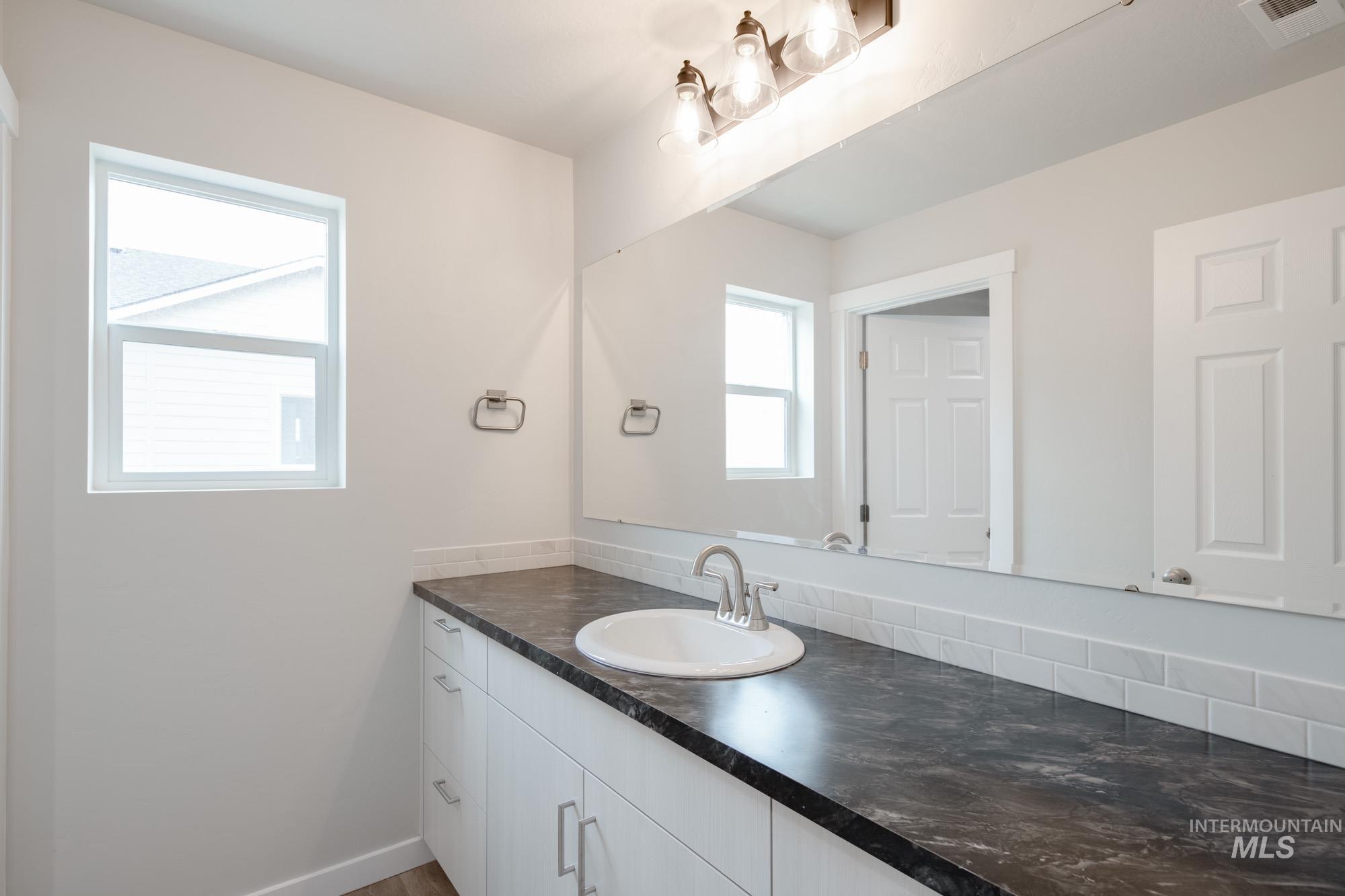 Bathroom with vanity and baseboards
