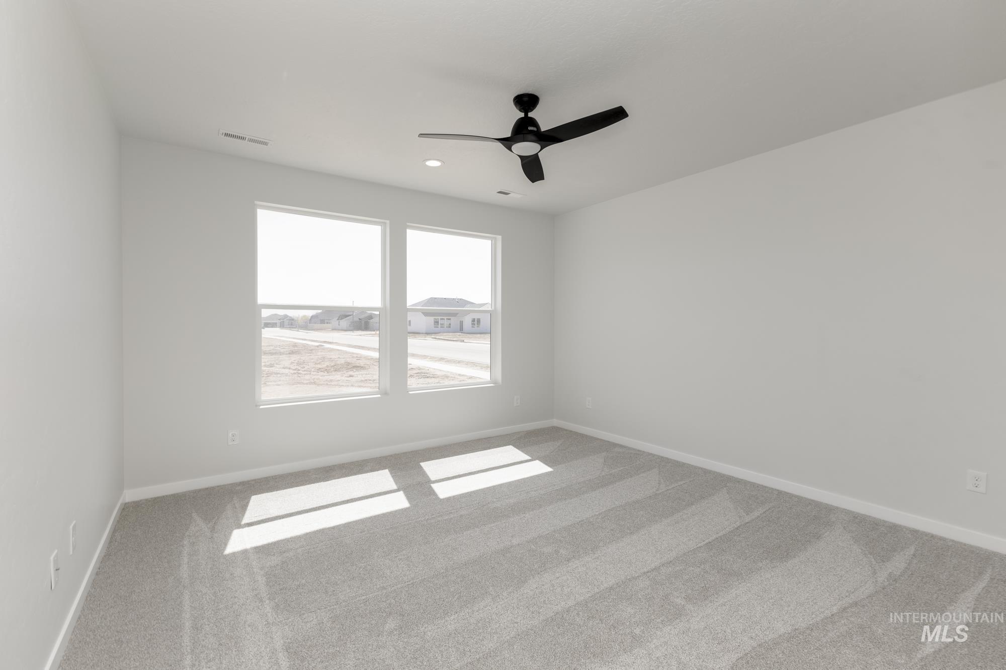 Empty room with carpet, ceiling fan, and recessed lighting